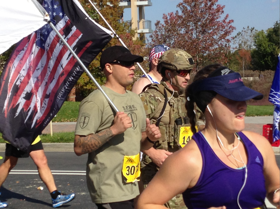 Veterans running with flag